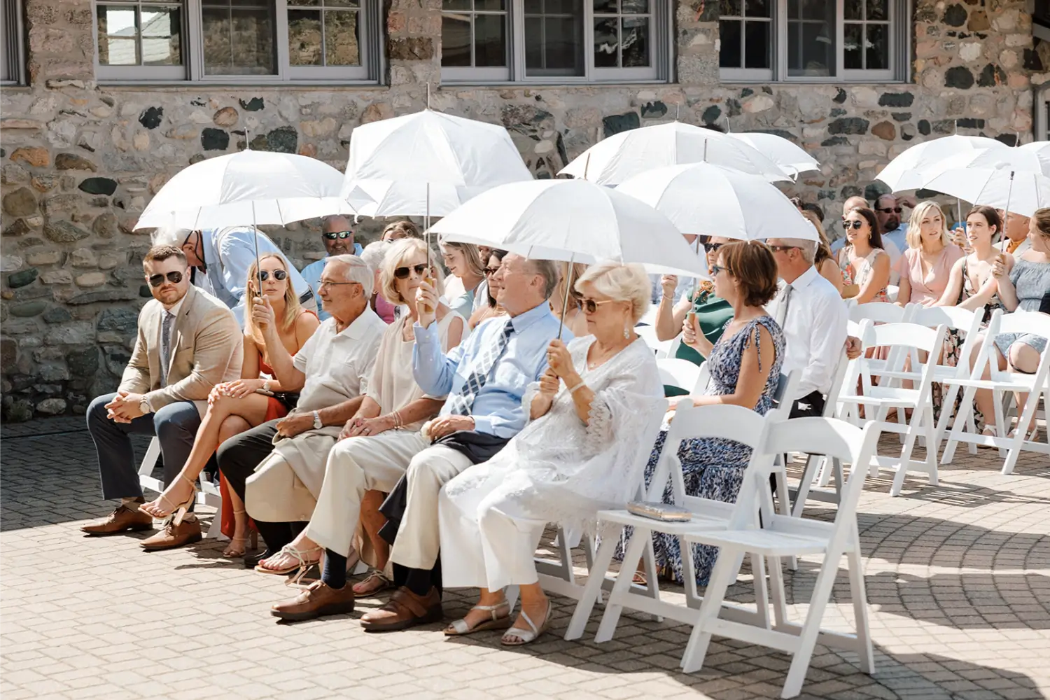 guests holding umbrellas at Wedding at Castle Farms