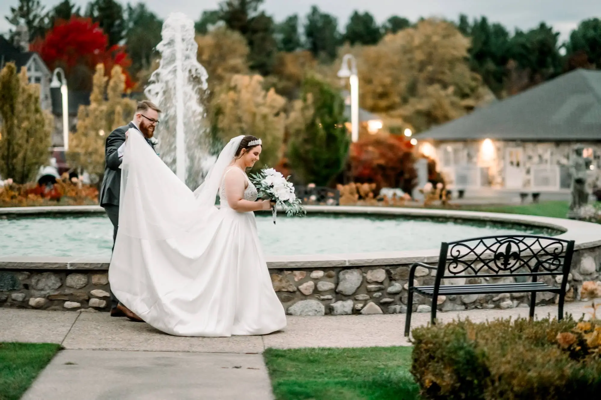 Groom holding up Bride's Dress by Lux Light Photography