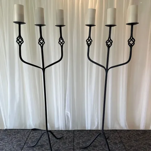 Two candelabras in front of a white background at Castle Farms.