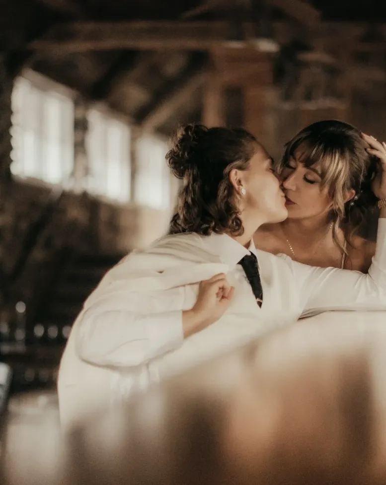 A couple kissing beside a bar in the tavern at Castle Farms. 