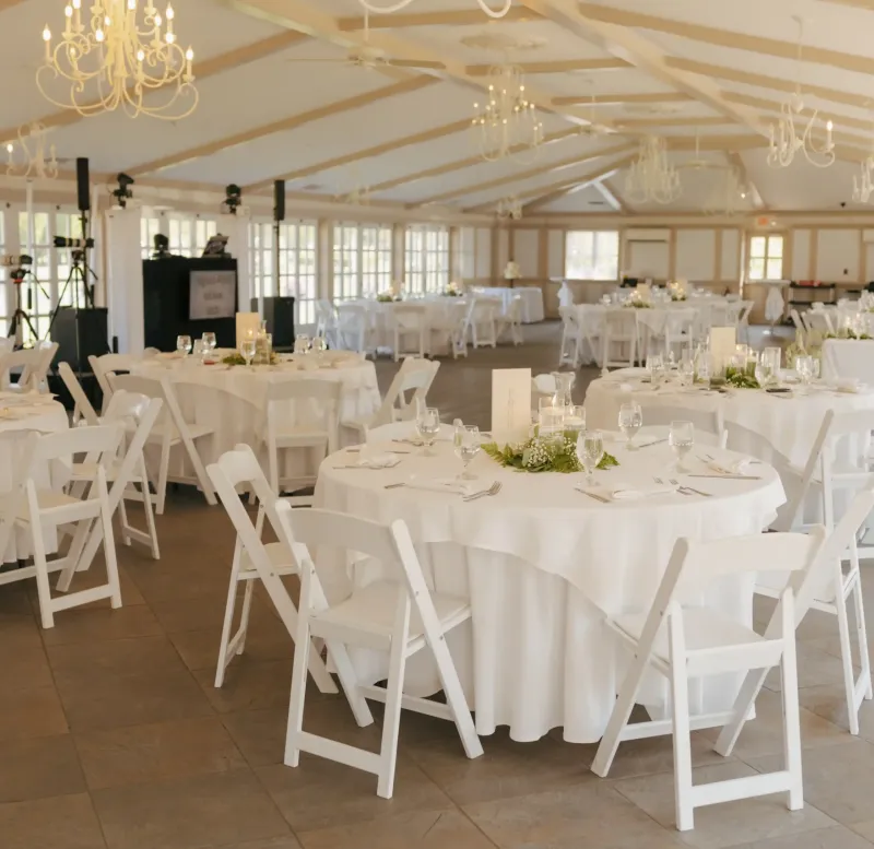 The West Garden room set up with tables, chairs, and equipment at Castle Farms.