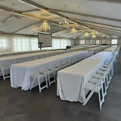 Long tables with chairs in an event space at Castle Farms
