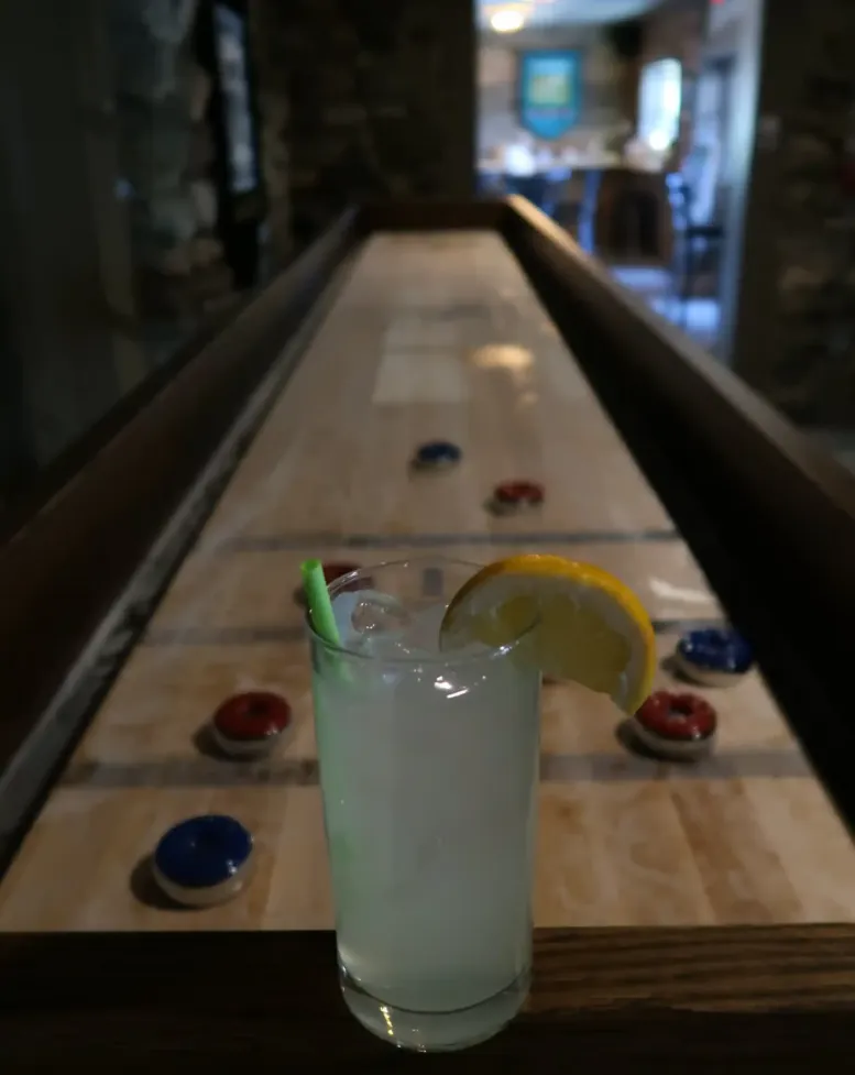A drink sitting on a game table in the Castle Pub at Castle Farms.