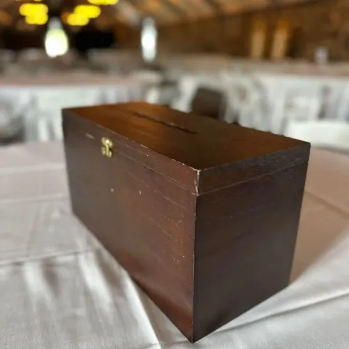 A wooden box card holder on a table at Castle Farms.