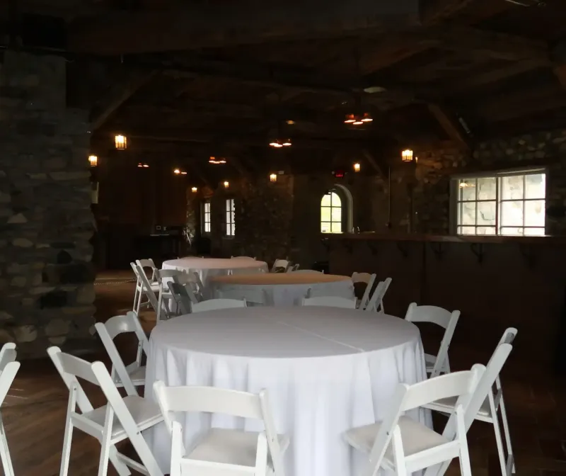 Dark tavern with tables and chairs at Castle Farms.