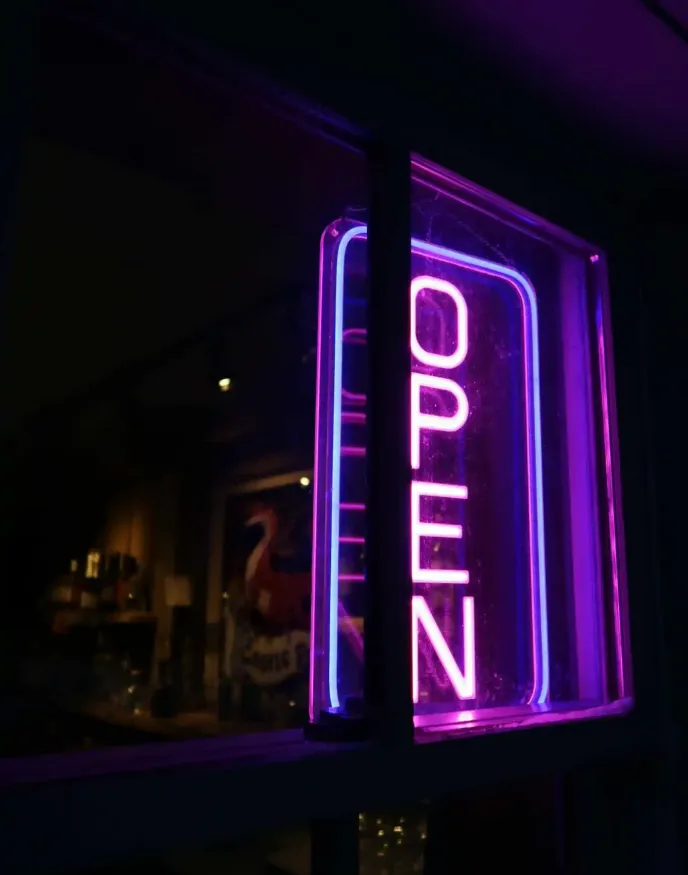 A purple neon open sign at the pub at Castle Farms.