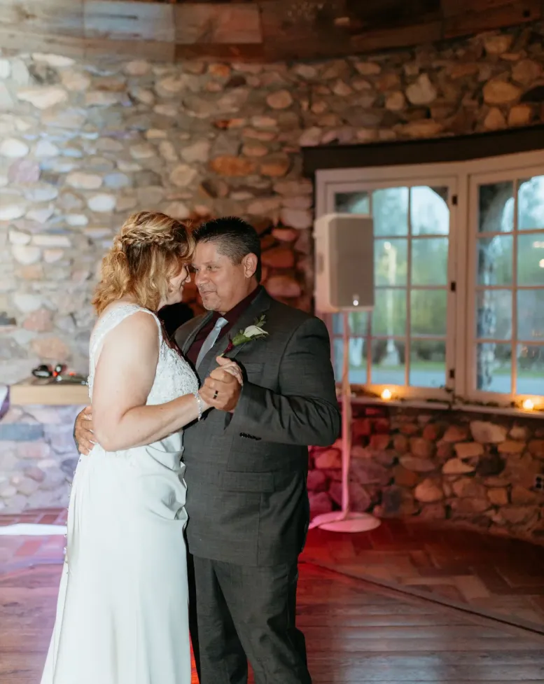A man dancing with the bride on the dance floor of the tavern at Castle Farms.