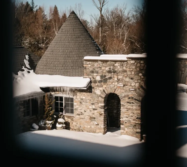 Snow-covered stone architecture at Castle Farms during the holiday season