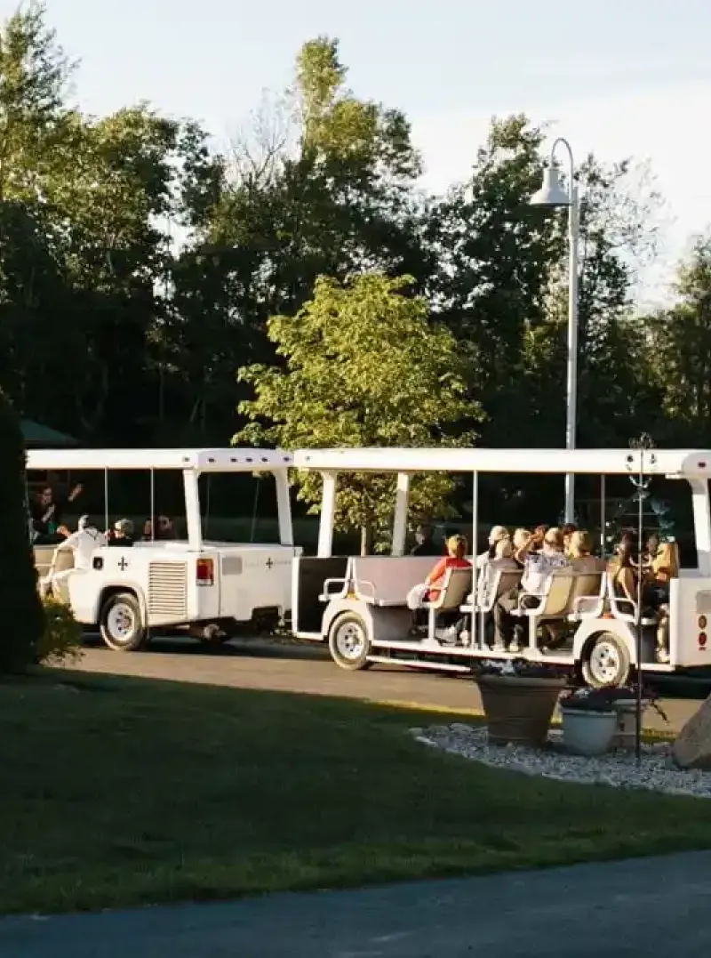 A trolley shuttles people around a corner of the gardens of Castle Farms.