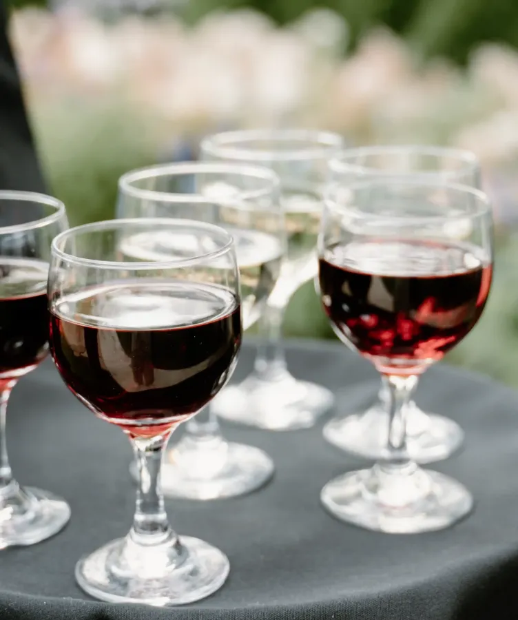Wine glasses on a black table outside at Castle Farms.