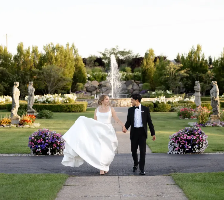 A bride and groom in the gardens of Castle Farms.
