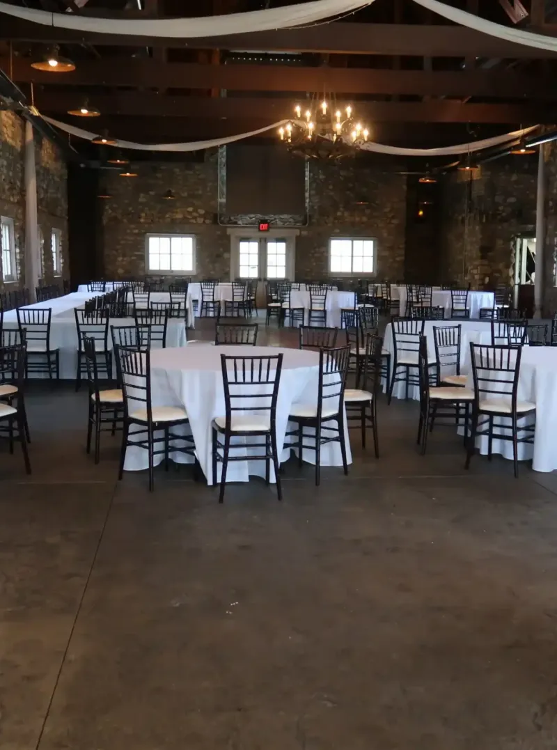 The Knight's Castle scattered with chairs and tables for a reception at Castle Farms.