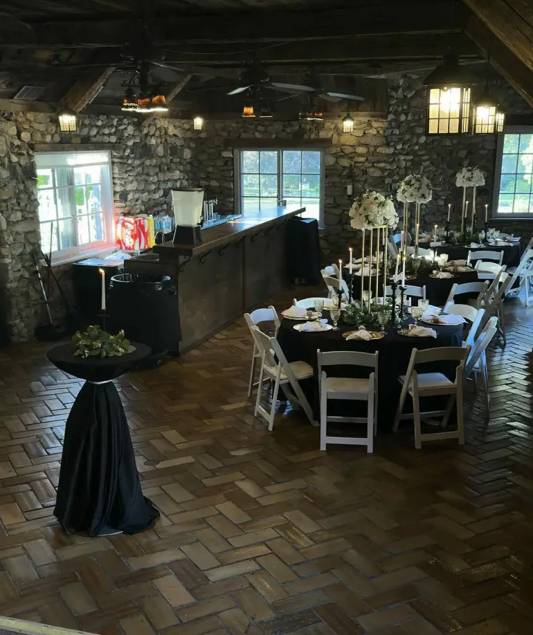 Tables and chairs set up around a decorated tavern at Castle Farms.