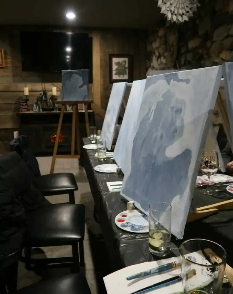 A row of painted easels at a painting event at the Castle Pub at Castle Farms. 
