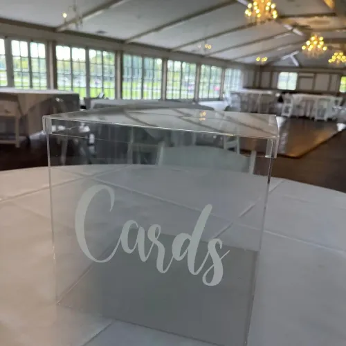 A clear card box on a table at Castle Farms.