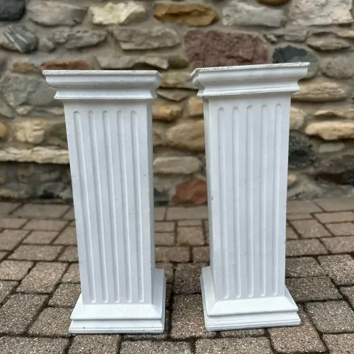 Two square white pillars at Castle Farms.