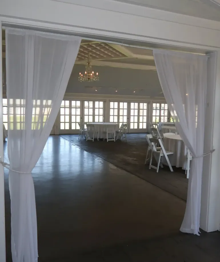 Curtains hanging from the top of a doorway in an event space at Castle Farms.