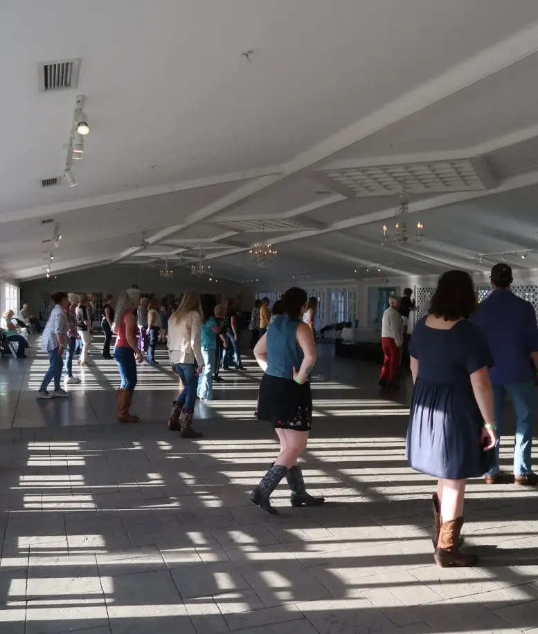 People line dancing in an event space at Castle Farms.