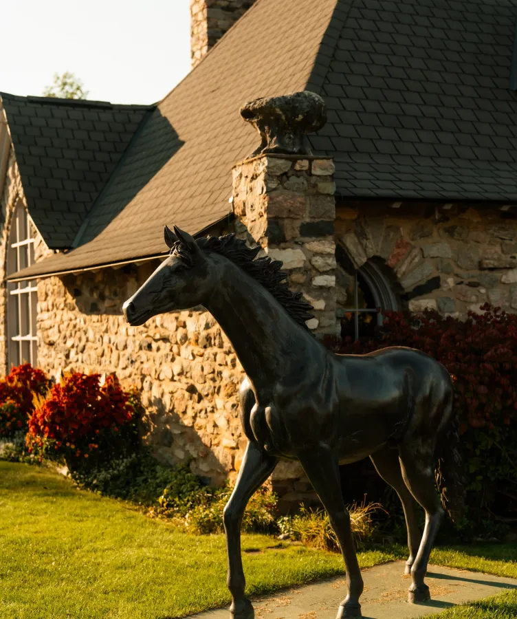 A metal horse statue beside a building at Castle Farms.