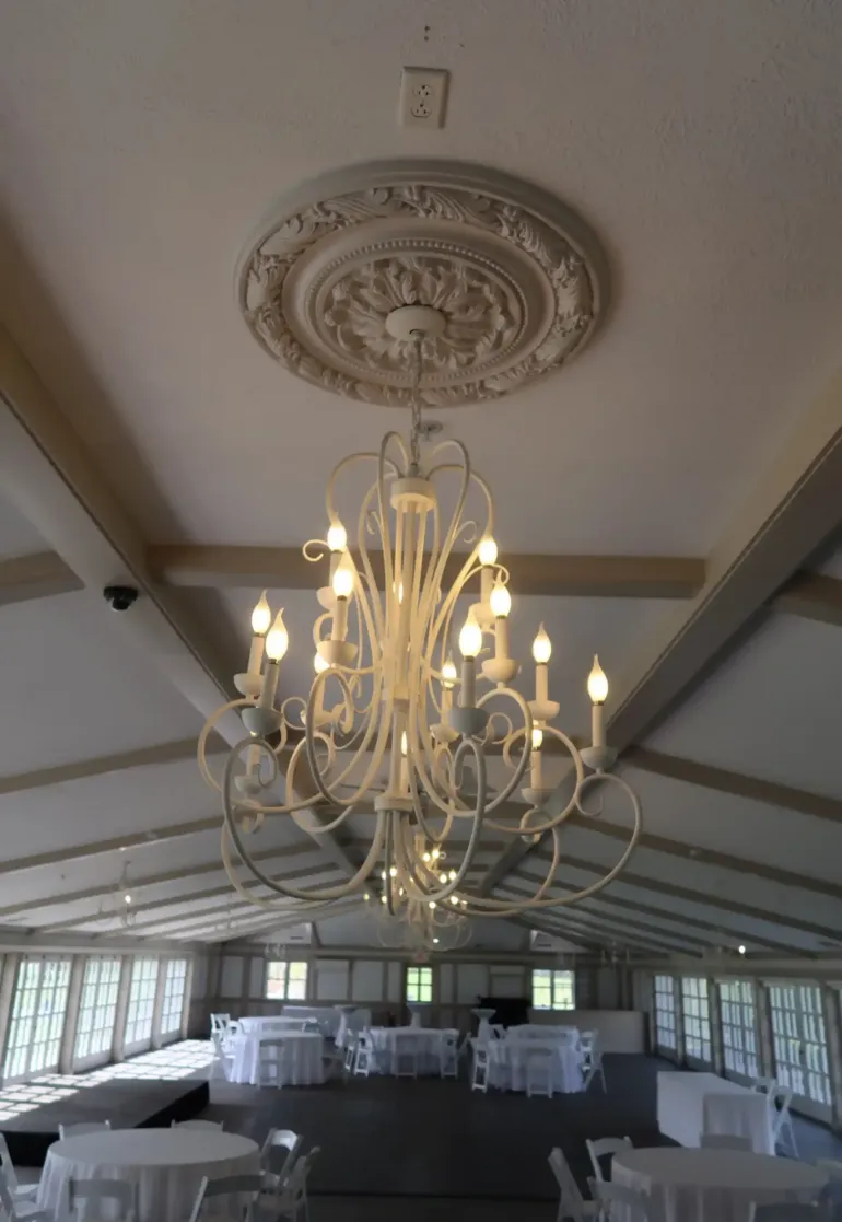 An ornate chandelier and ceiling in an event space at Castle Farms. 