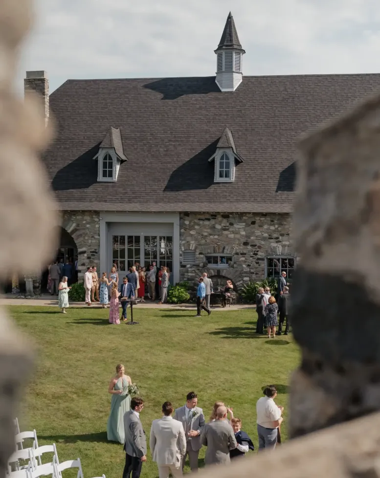 A view from a castle of a wedding reception on green grass at Castle Farms. 