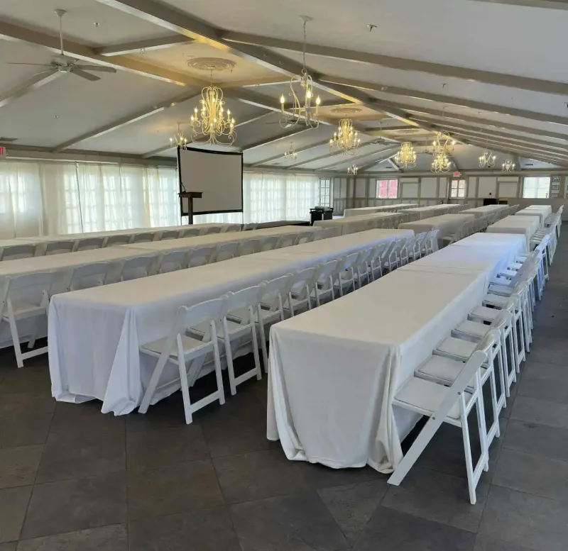 Long tables with chairs in an event space at Castle Farms