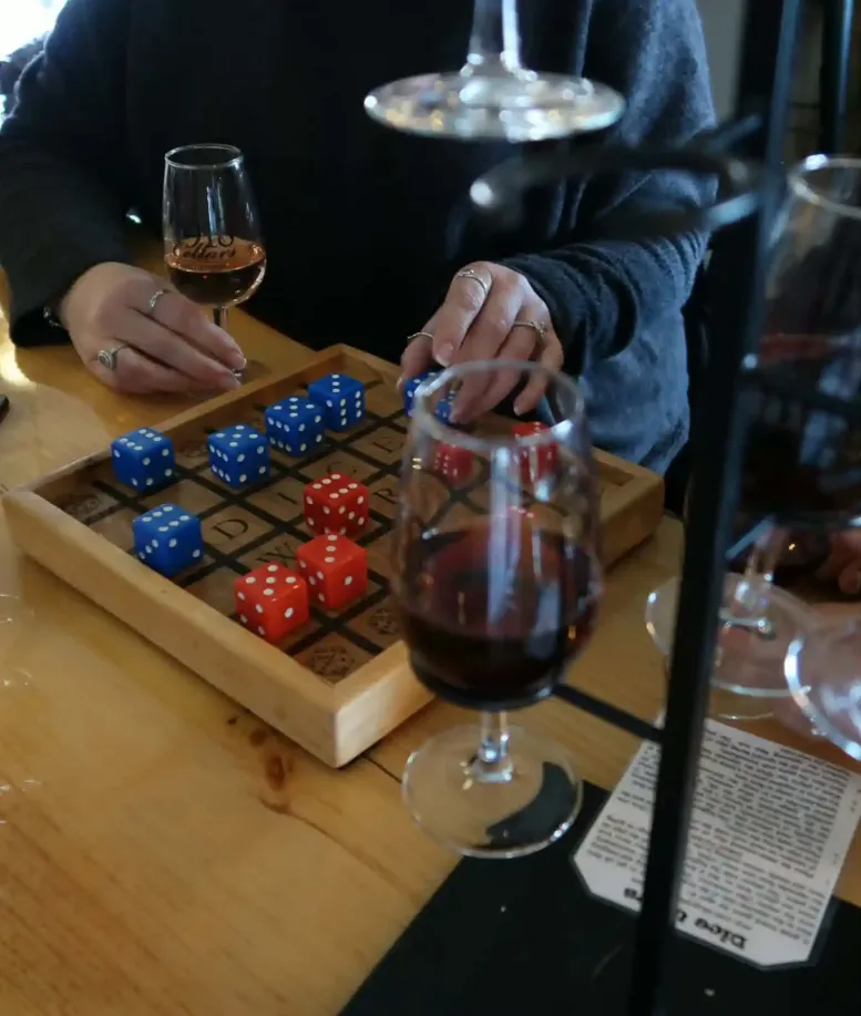 People playing dice games at a table at Castle Farms.