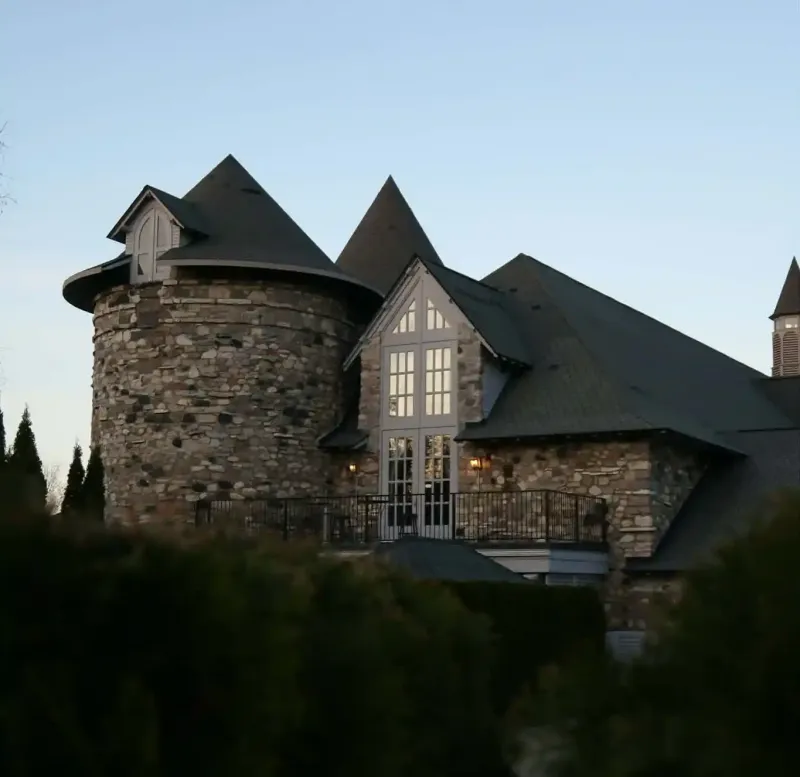 A castle above trees during the evening at Castle Farms.