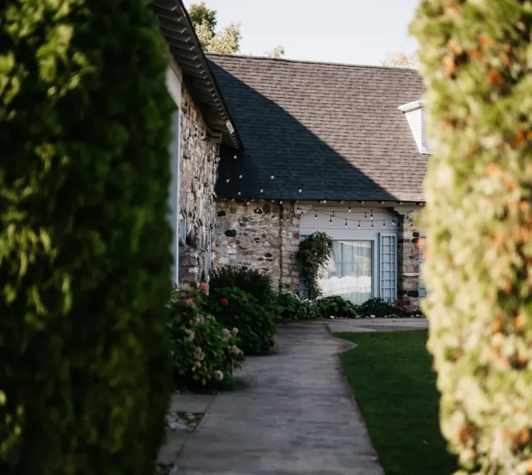 A sidewalk leading to a yard next to a building at Castle Farms.