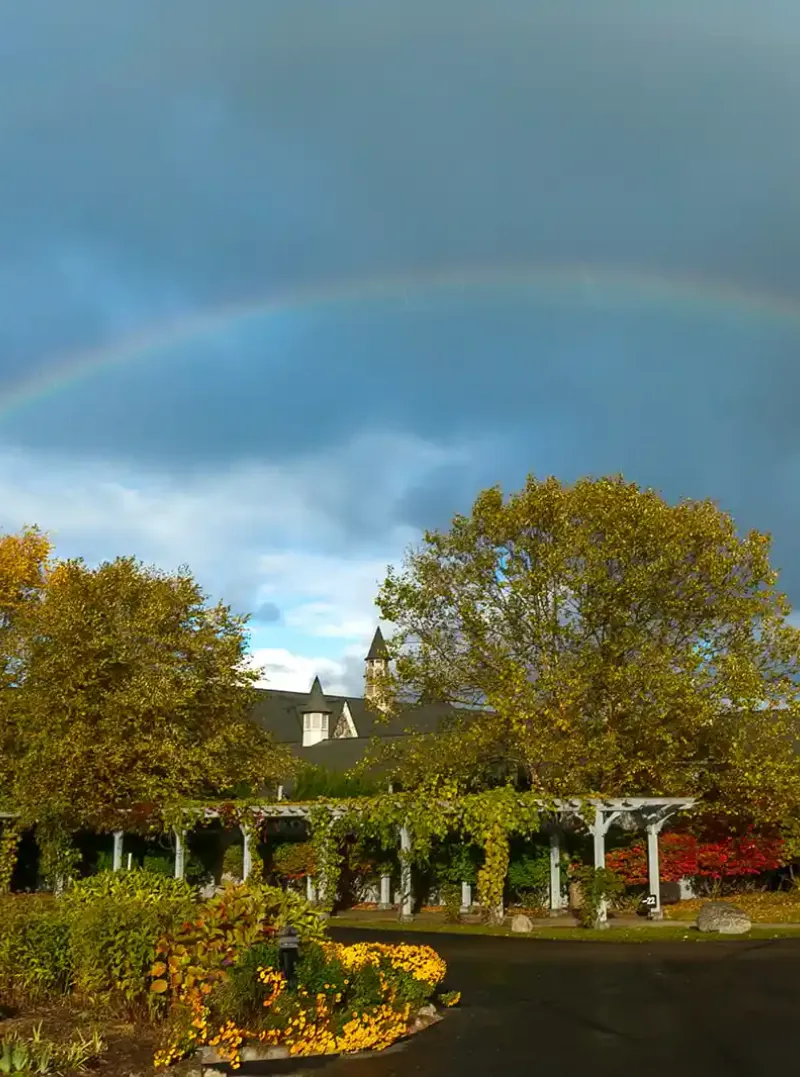 A rainbow arches over the gardens of Castle Farms.