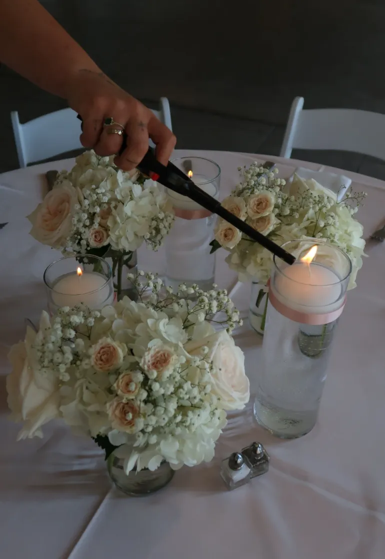 Wedding table decor with floral centerpieces and candles at Castle Farms