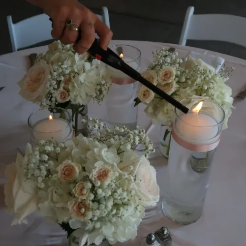 Wedding table decor with floral centerpieces and candles at Castle Farms